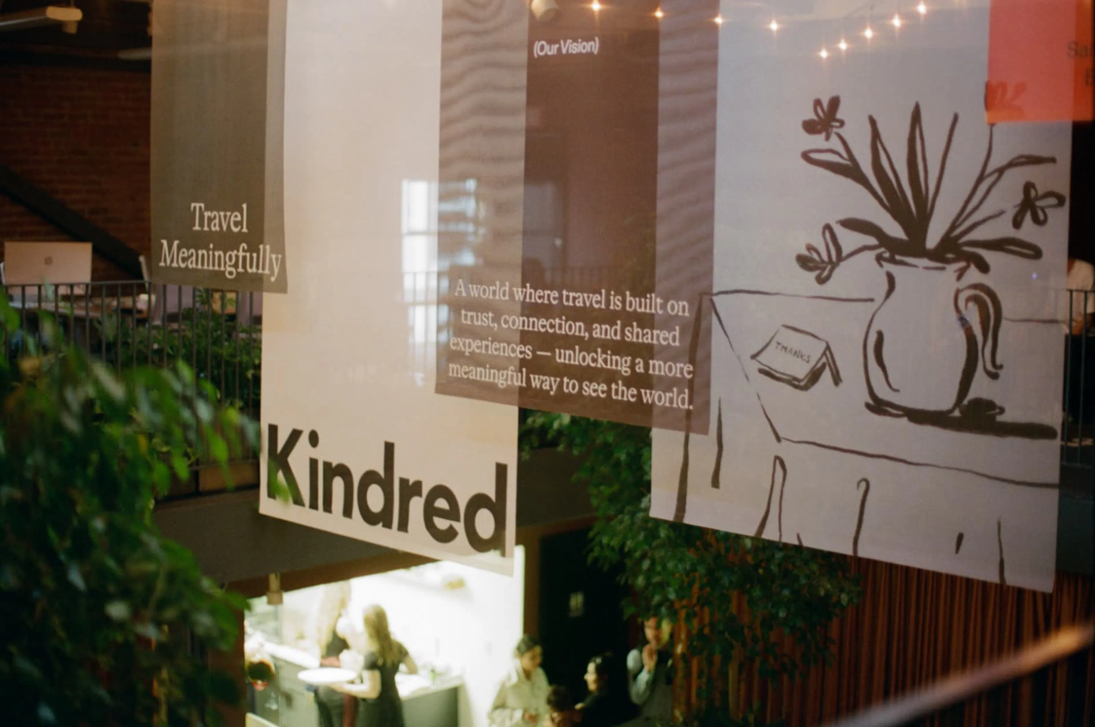 Kindred ‘Travel Meaningfully’ banners hanging at an event space.